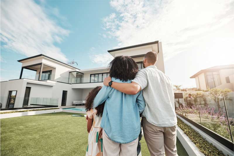 Real Estate Law, family standing in from of a new home